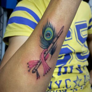 peacock feather with flute tattoo