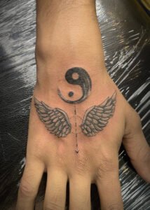 ying yang with wings tattoo