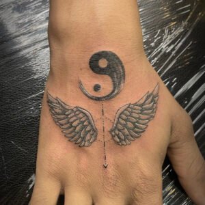 ying yang with wings tattoo
